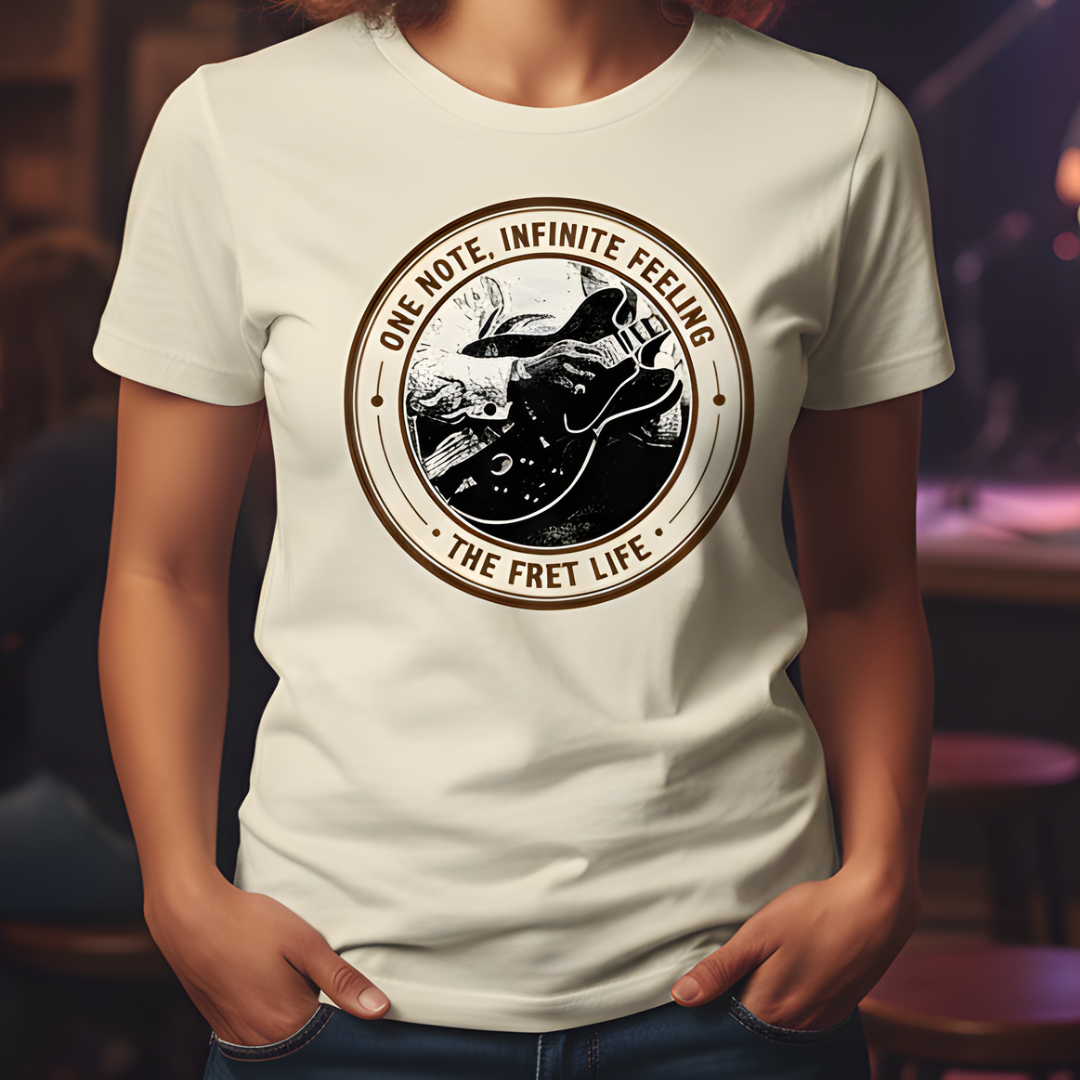 Person wearing a white t-shirt with a guitar graphic and text in a casual setting