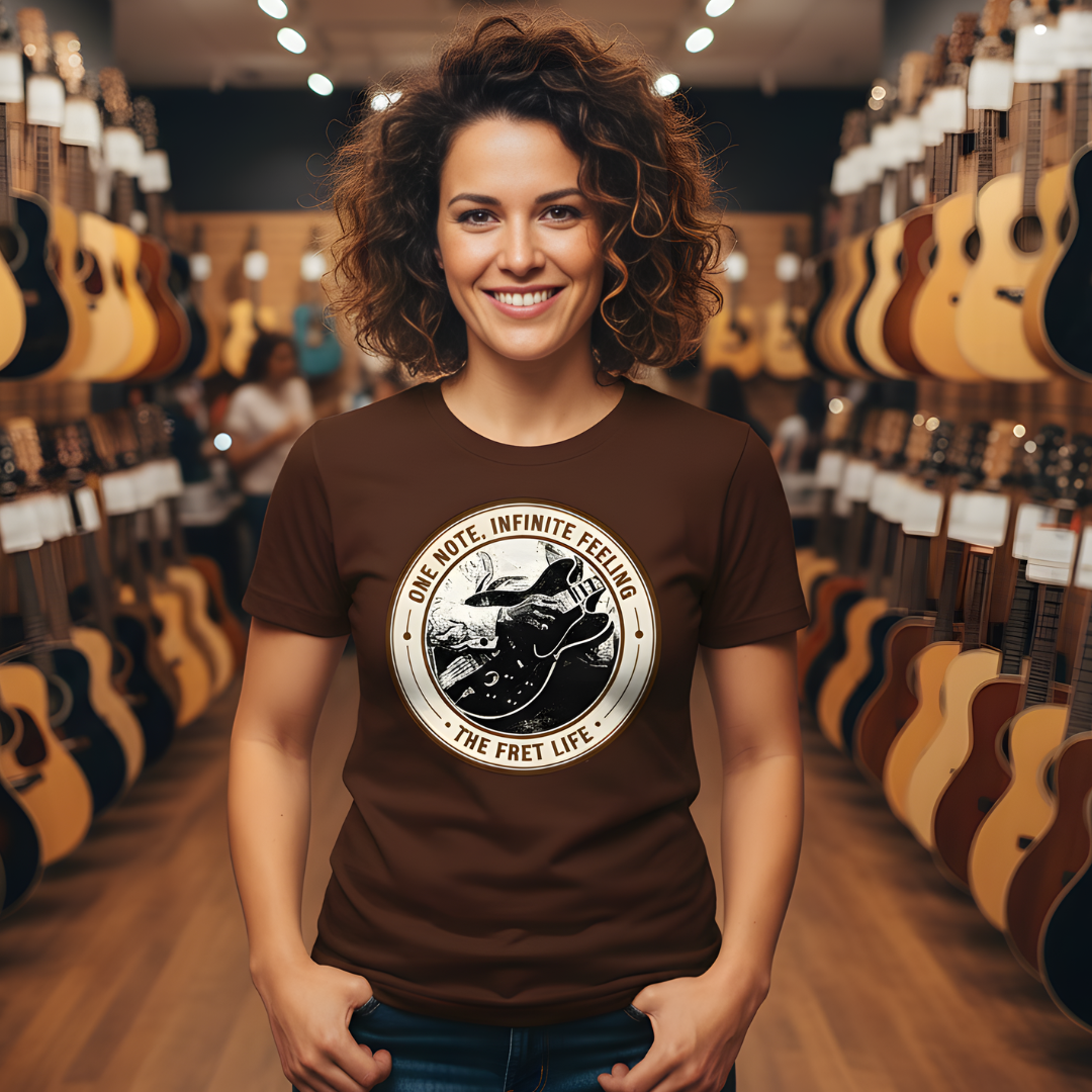 Woman wearing a brown t-shirt with a graphic design in a guitar store