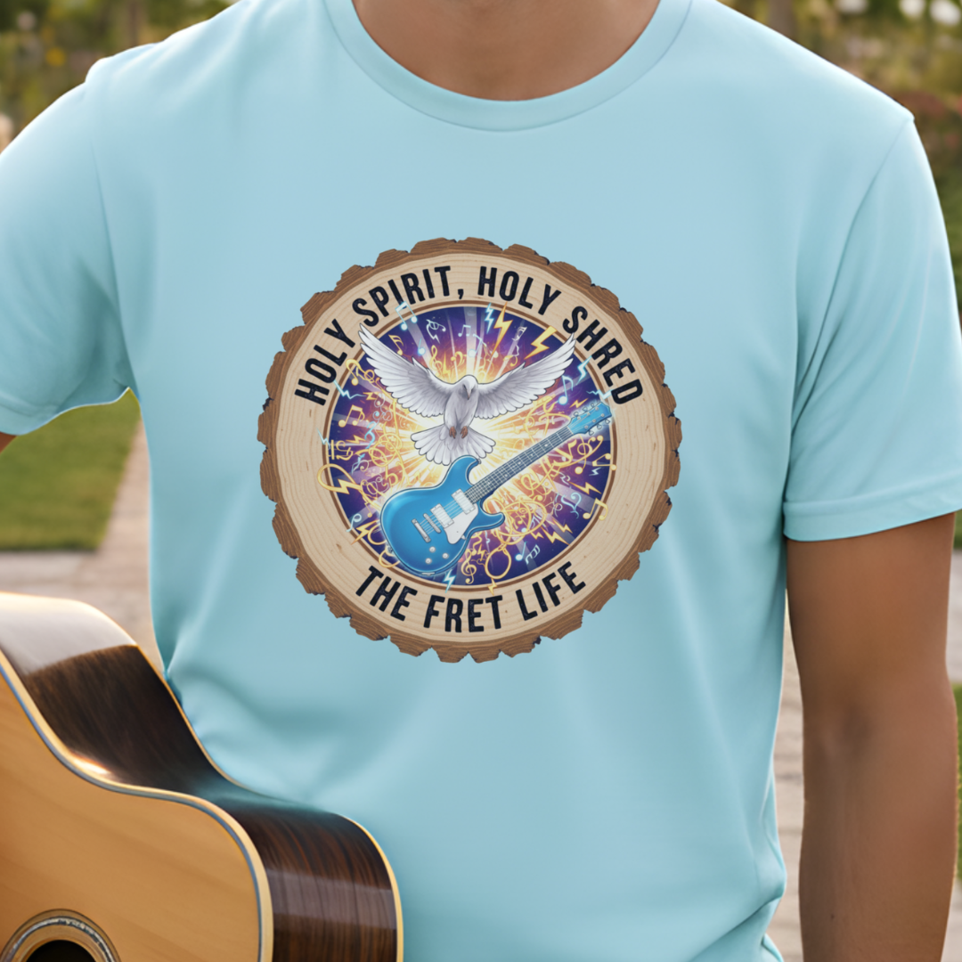 Person wearing a light blue t-shirt with a graphic design featuring a guitar and dove, with text 'Holy Spirit, Holy Shred The Fret Life'.