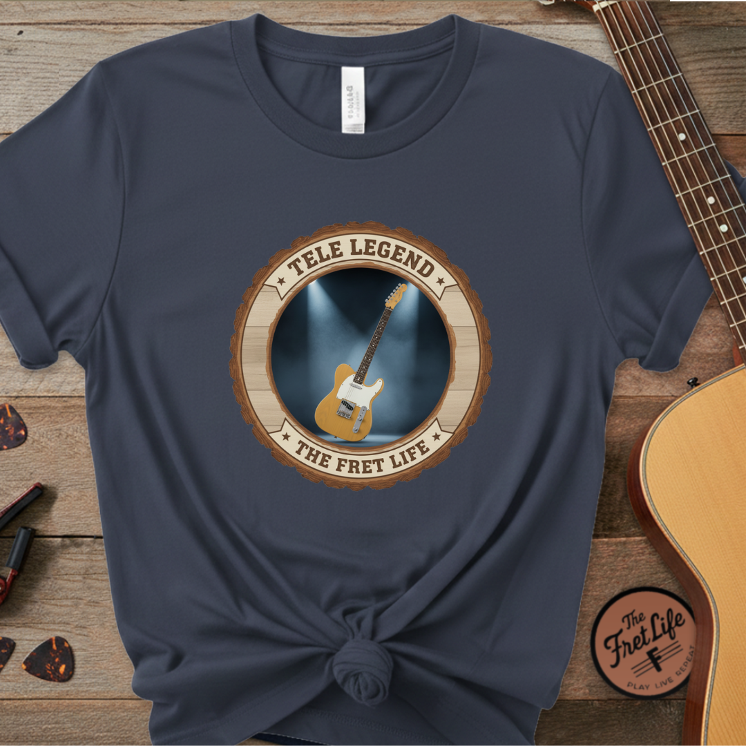 Navy blue t-shirt with guitar graphic and 'The Fret Life' text on a wooden background
