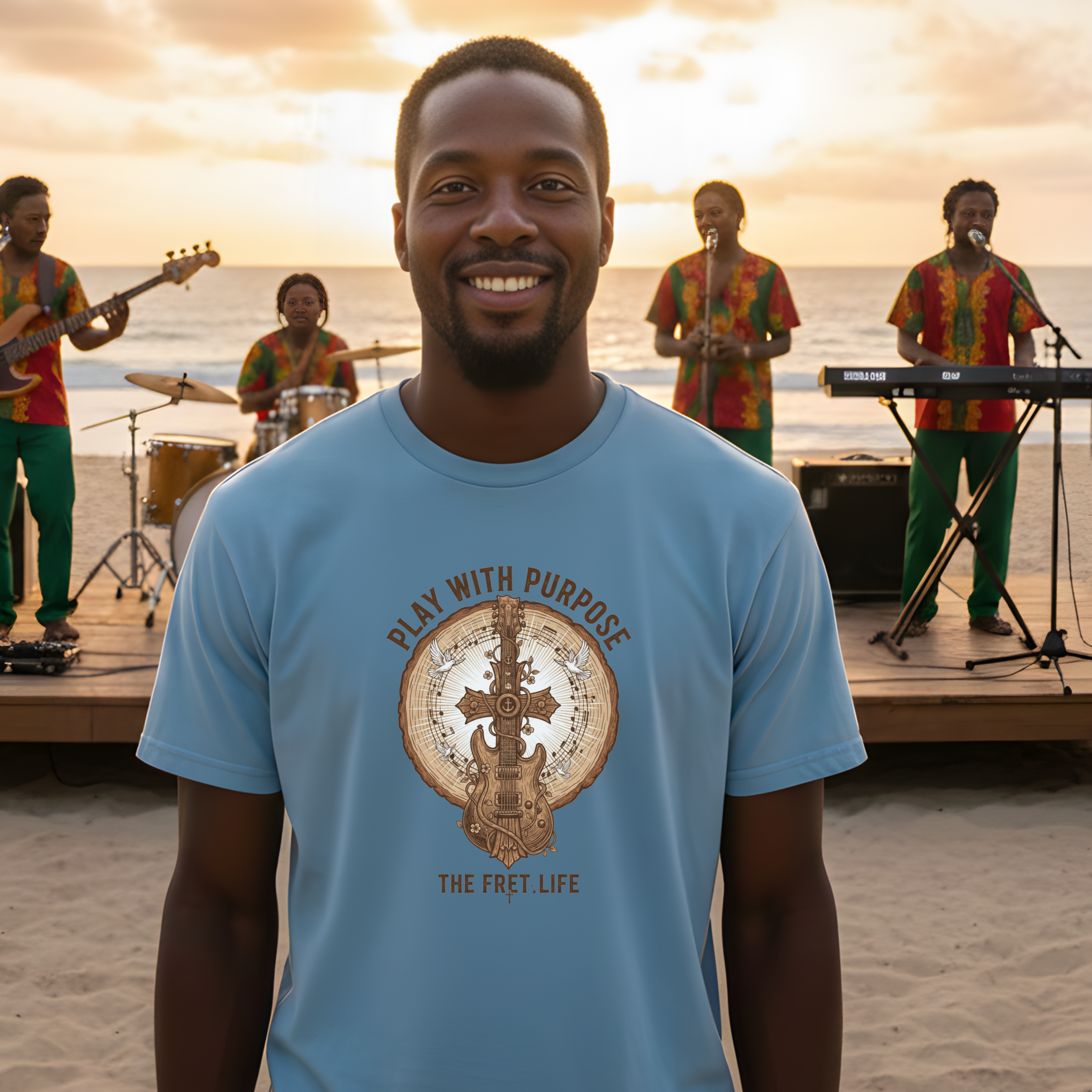 Man wearing a blue t-shirt with a guitar graphic and text, standing on a beach with a band in the background.