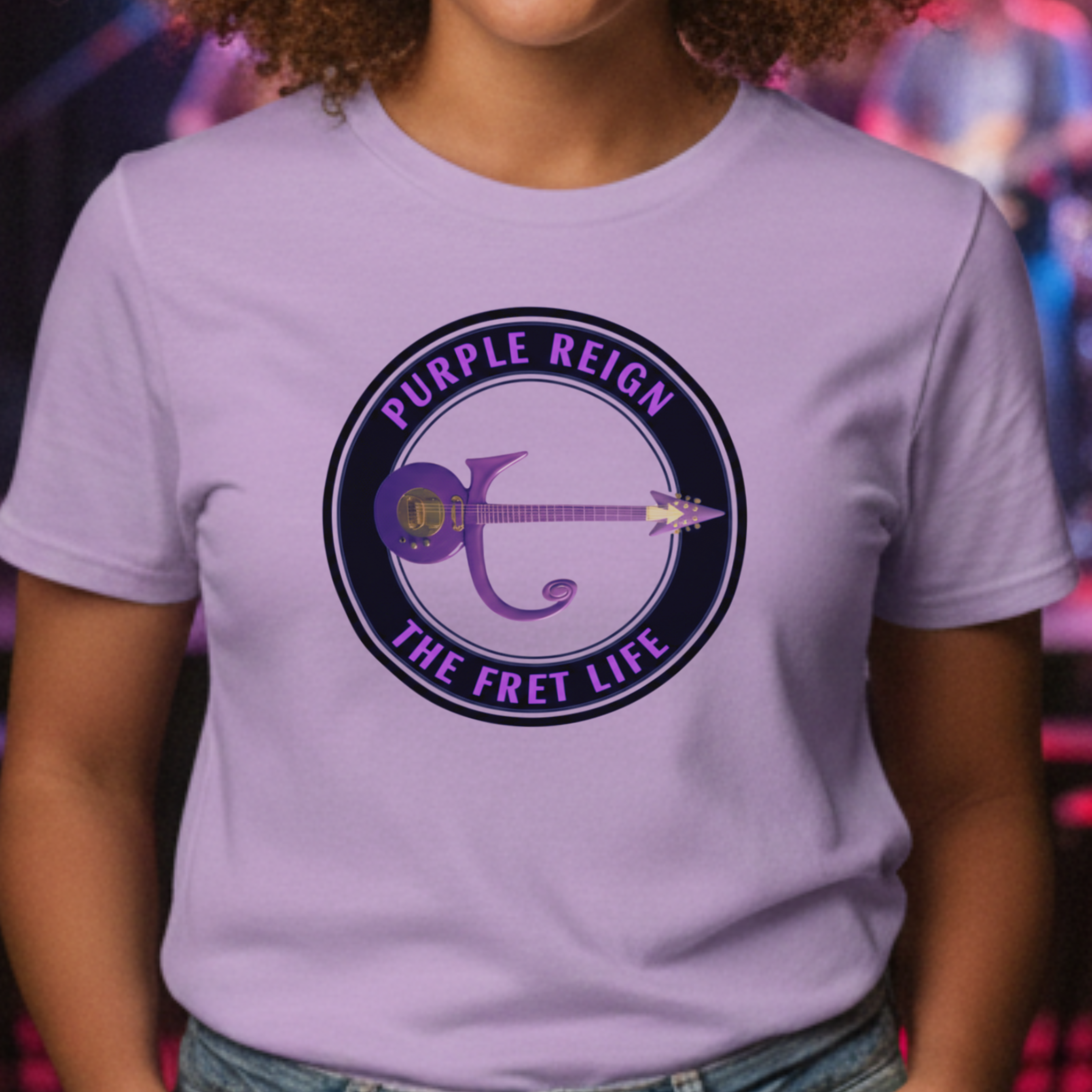 Person wearing a light purple t-shirt with 'Purple Reign: The Fret Life' graphic design.