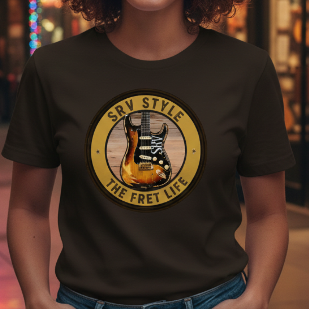 Person wearing a black t-shirt with a guitar graphic and text in a casual setting