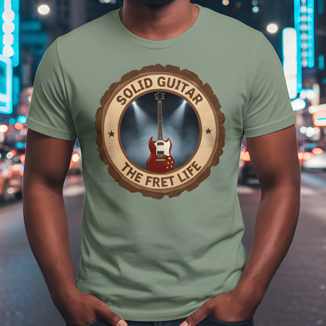 Person wearing a green t-shirt with a guitar graphic and text in an urban setting