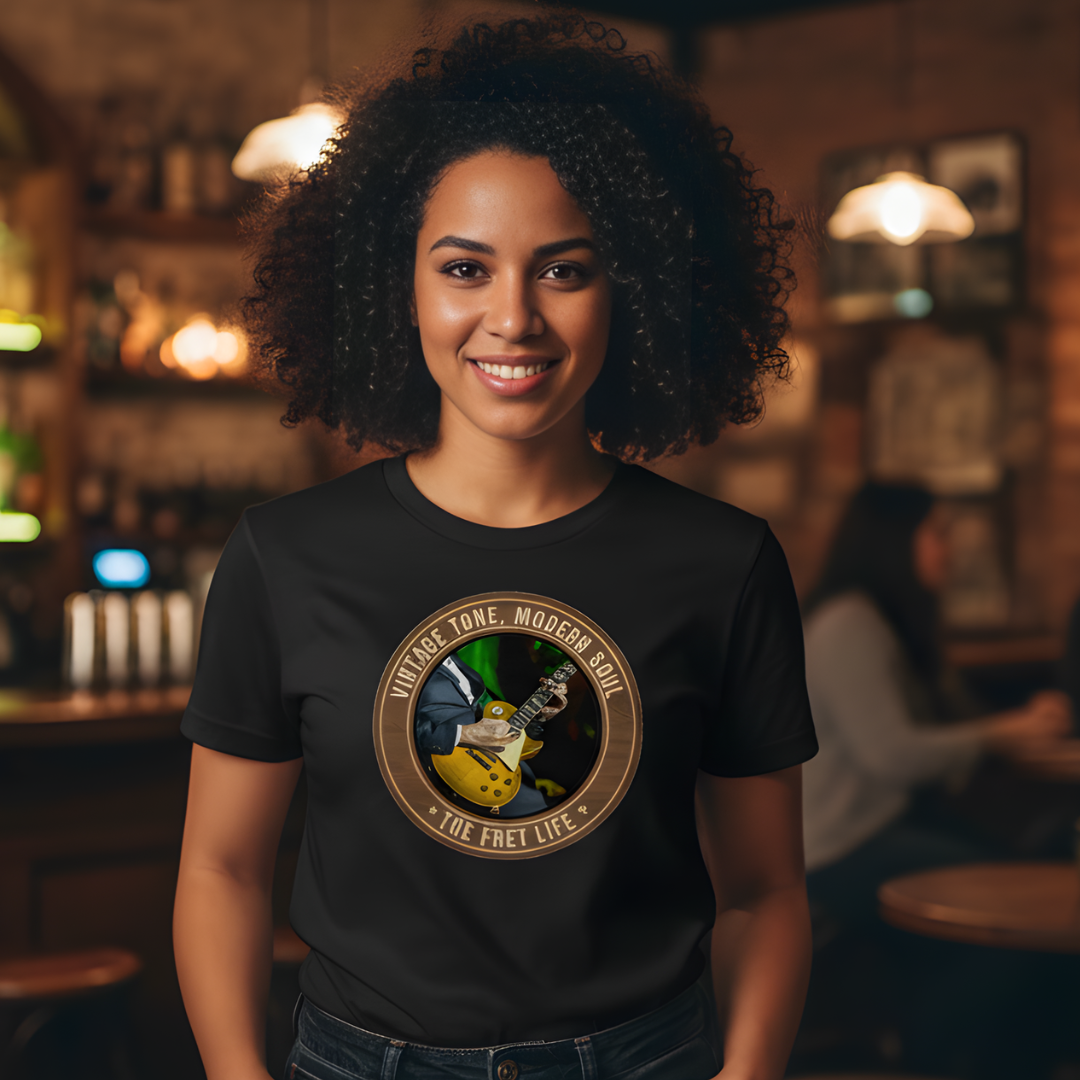 Person wearing a black t-shirt with a graphic design in a bar setting