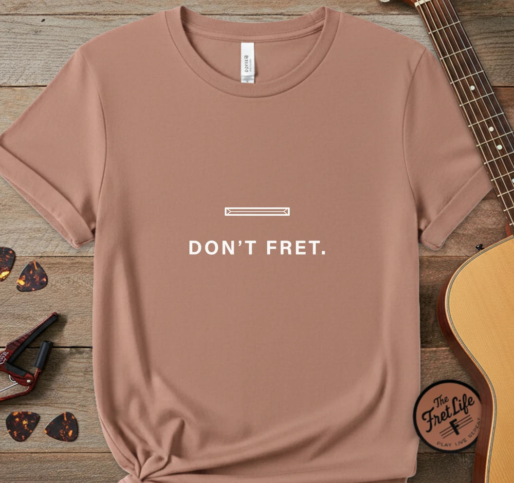 https://wescale-cdn.com/generated-mockups/06643e60-6f9f-4676-8a50-5fdfdc8f17c0/95c6ccee-668c-484f-a77b-49edc5ba2269/ab900b60-3c14-47cd-934c-3a072b8518c6_designs/don_t_fret_white_1775678215758_kf0nk2.png.webp